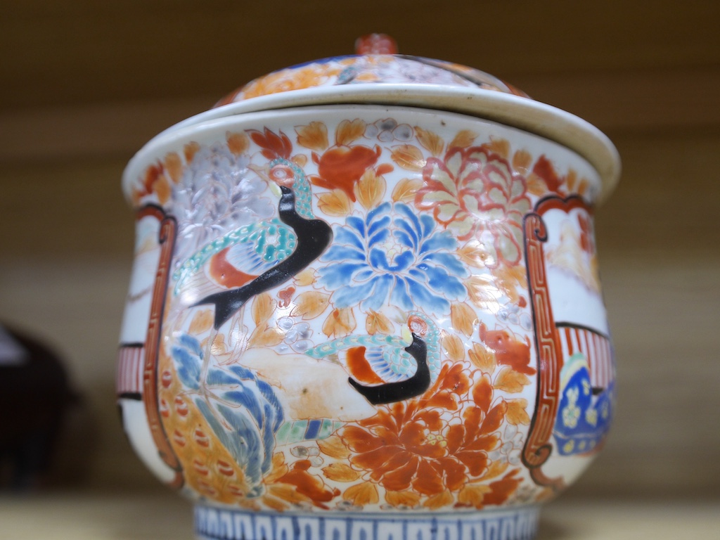 A Japanese porcelain Imari lidded pot, 26cm wide. Condition - fair to good